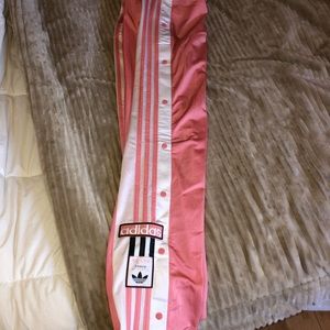 Small, pink Adidas track pants